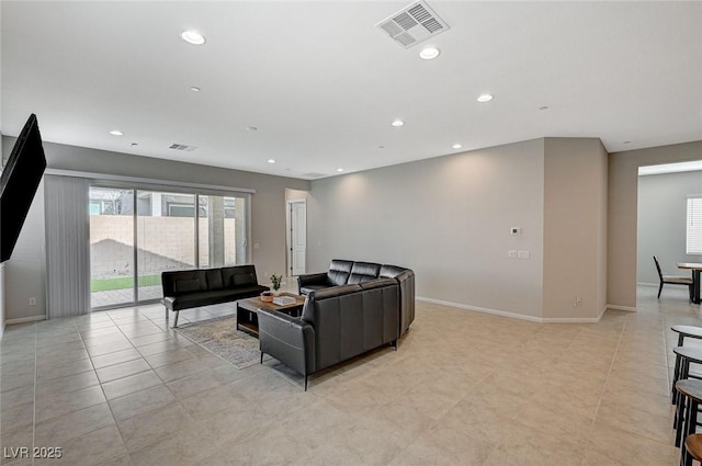 living area with recessed lighting, visible vents, and a healthy amount of sunlight