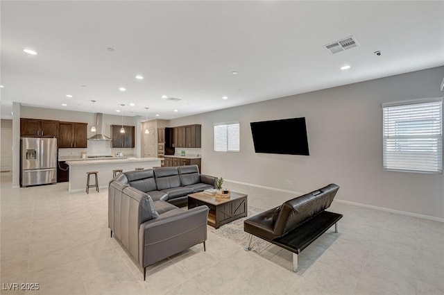 living room with visible vents, recessed lighting, and baseboards