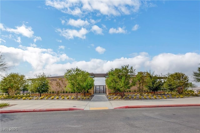 view of front of home with a gate and stucco siding