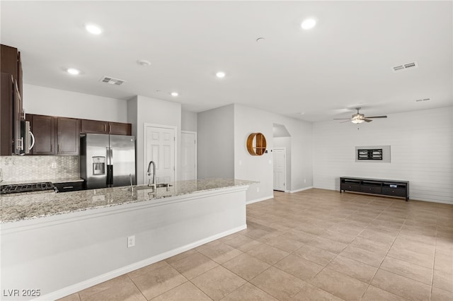 kitchen with visible vents, dark brown cabinets, stainless steel appliances, and a sink