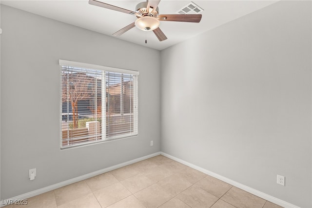 unfurnished room featuring light tile patterned floors, baseboards, visible vents, and ceiling fan