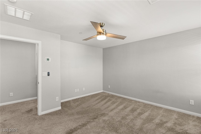 spare room with visible vents, carpet floors, baseboards, and a ceiling fan