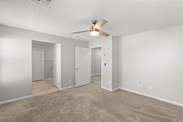 unfurnished bedroom with visible vents, carpet flooring, a ceiling fan, and baseboards