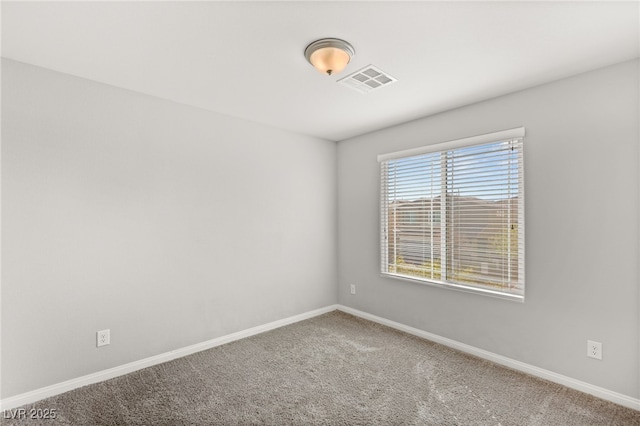 unfurnished room with carpet, baseboards, and visible vents