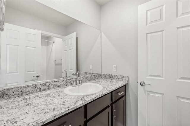 full bathroom with vanity and walk in shower