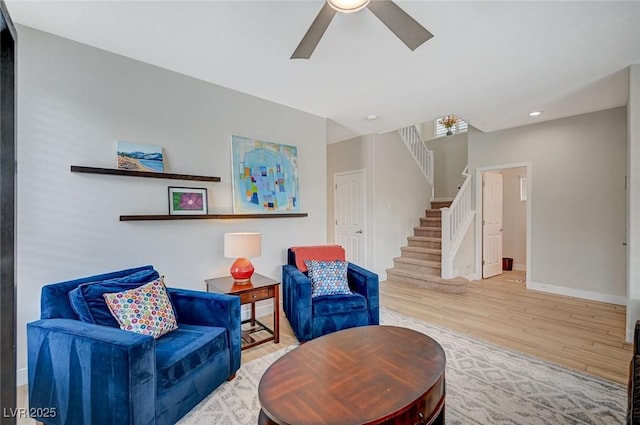 sitting room with baseboards, stairway, recessed lighting, wood finished floors, and a ceiling fan