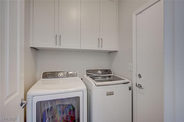 laundry room with cabinet space and washer and clothes dryer