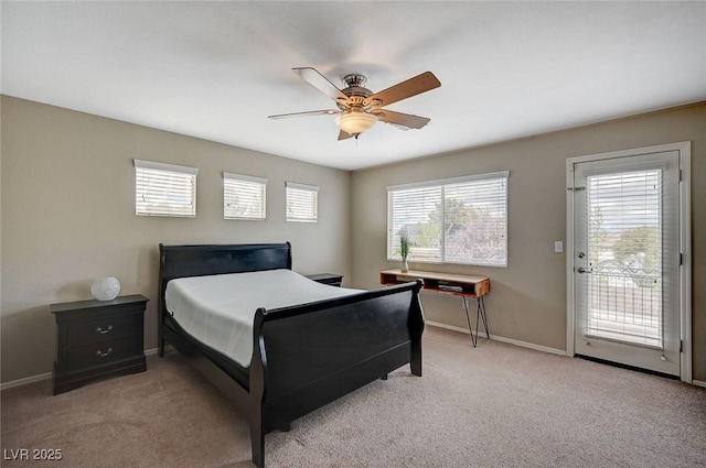 carpeted bedroom featuring access to exterior, a ceiling fan, and baseboards