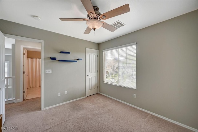 unfurnished bedroom featuring a ceiling fan, baseboards, visible vents, a closet, and carpet flooring