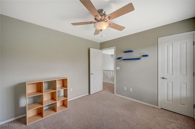 unfurnished bedroom with a ceiling fan, baseboards, and carpet floors