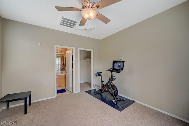 workout room with baseboards, light colored carpet, visible vents, and ceiling fan