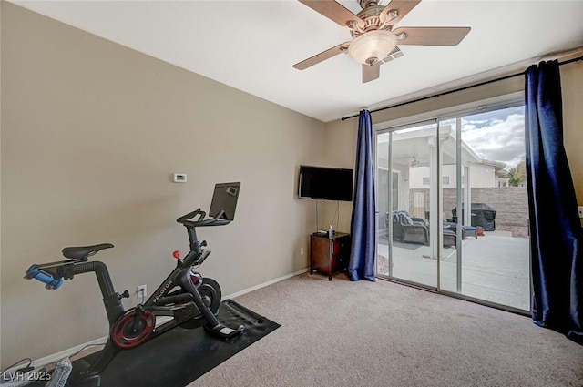 exercise room with baseboards, ceiling fan, and carpet floors