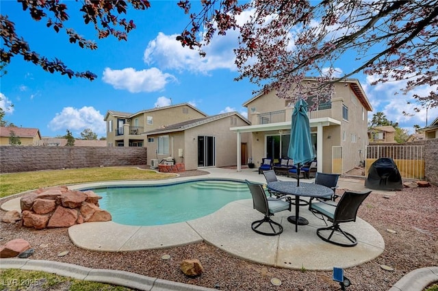 view of pool featuring a patio area, a fenced in pool, and a fenced backyard