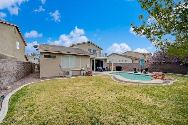 rear view of house with a patio area, a fenced in pool, a fenced backyard, and a lawn