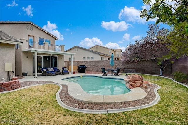 view of swimming pool with a patio, a fenced backyard, a lawn, and grilling area