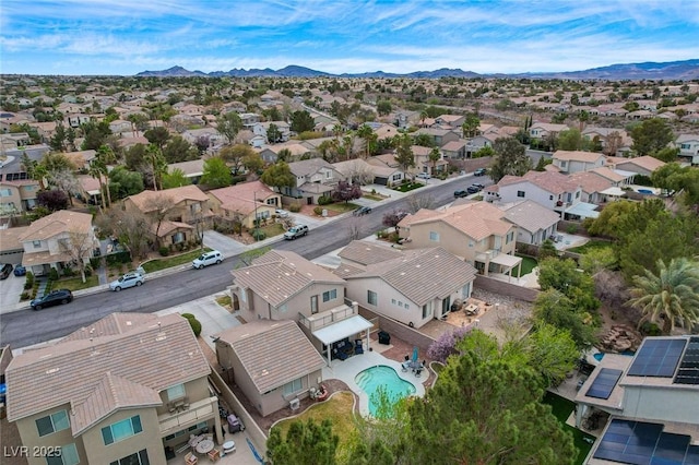 birds eye view of property with a mountain view and a residential view