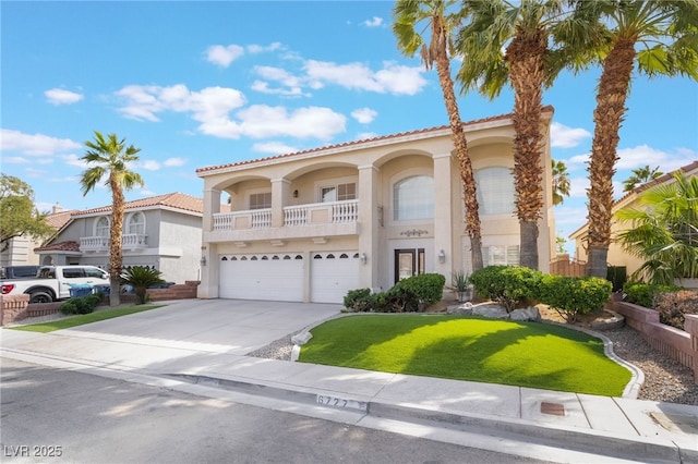 mediterranean / spanish-style house with stucco siding, concrete driveway, and a garage