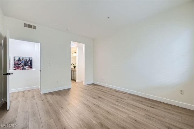 unfurnished bedroom with light wood-style flooring, baseboards, and visible vents