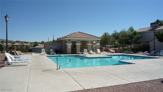 community pool featuring a patio area and fence