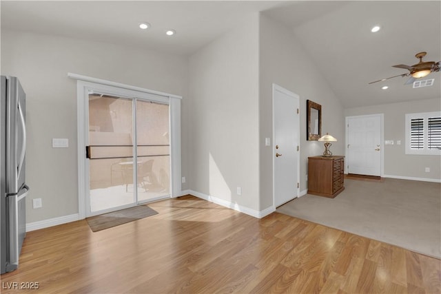 unfurnished room with visible vents, recessed lighting, light wood-type flooring, and lofted ceiling