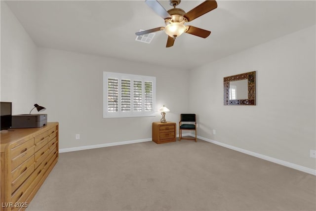 sitting room with a ceiling fan, visible vents, light colored carpet, and baseboards