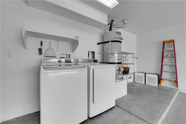 laundry room featuring laundry area, washing machine and dryer, and secured water heater