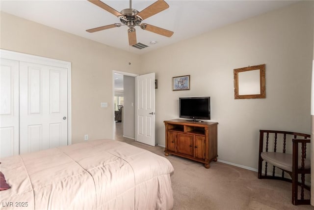 bedroom featuring light carpet, visible vents, ceiling fan, and a closet