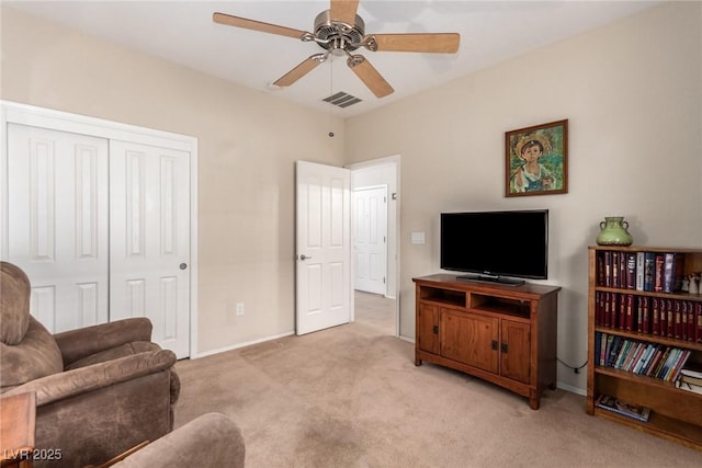 living area featuring ceiling fan, light colored carpet, visible vents, and baseboards