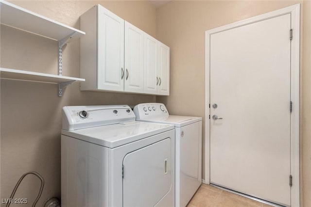 washroom with cabinet space, independent washer and dryer, and light tile patterned flooring