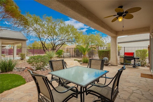 view of patio featuring a ceiling fan, outdoor dining area, and a fenced backyard