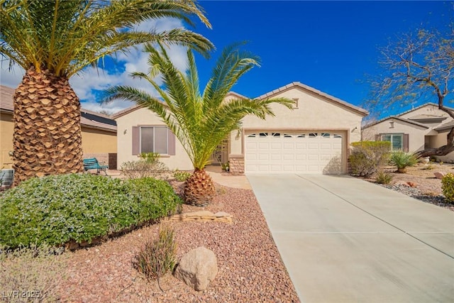 view of front of house with a garage, driveway, and stucco siding