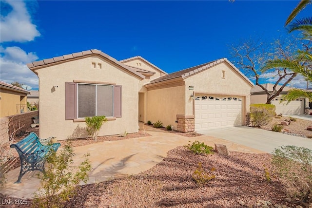 mediterranean / spanish house with stucco siding, a garage, and driveway