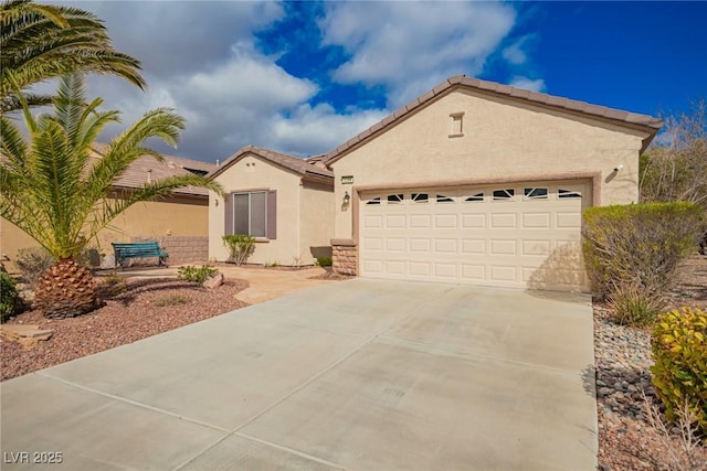 mediterranean / spanish home with a tile roof, an attached garage, driveway, and stucco siding