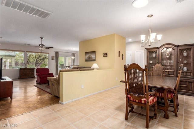 dining area featuring light tile patterned floors, visible vents, baseboards, and ceiling fan with notable chandelier