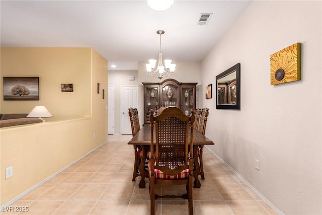 dining area with light tile patterned flooring, visible vents, baseboards, and an inviting chandelier