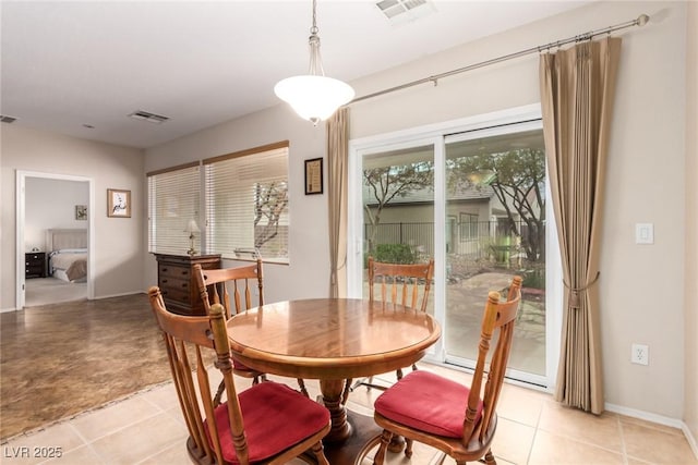 dining space featuring visible vents and baseboards