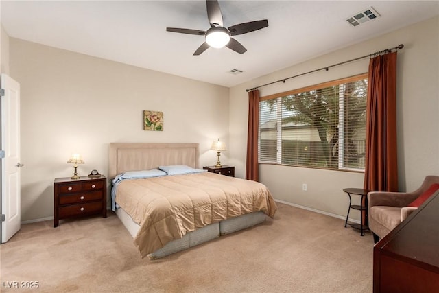 bedroom featuring baseboards, visible vents, and light carpet