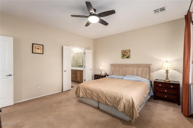 bedroom with visible vents, connected bathroom, baseboards, ceiling fan, and light colored carpet