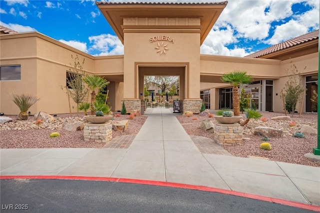 entrance to property with stucco siding and stone siding