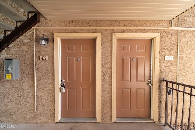 doorway to property with stucco siding