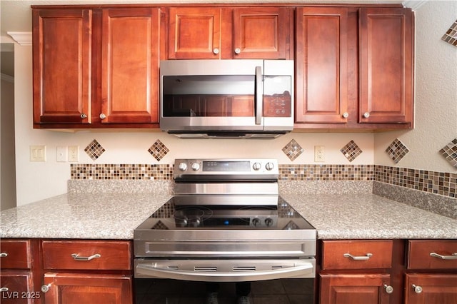 kitchen featuring decorative backsplash and appliances with stainless steel finishes