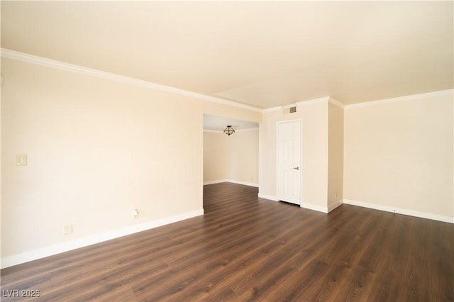 spare room featuring visible vents, dark wood-type flooring, and ornamental molding