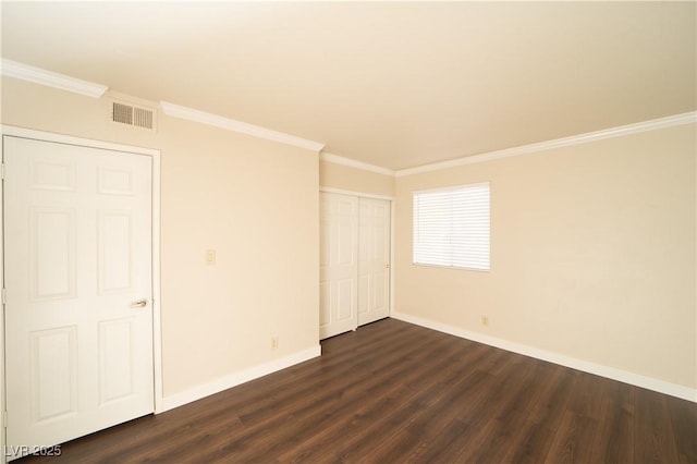 interior space with crown molding, dark wood-style floors, visible vents, and baseboards