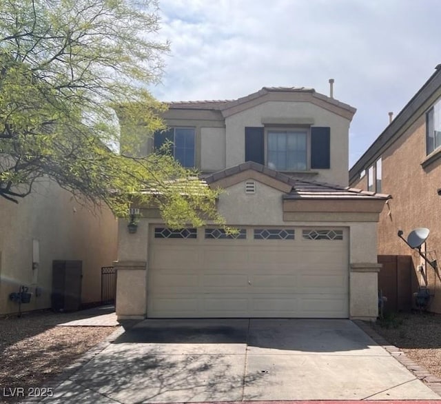 traditional-style home with stucco siding, a tiled roof, driveway, and a garage