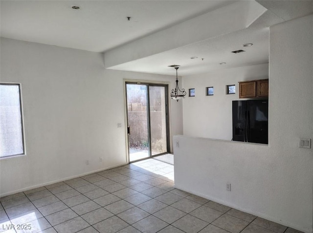 8301 Strawberry Spring St, Las Vegas, NV 89143 - empty room featuring light tile patterned floors and a chandelier