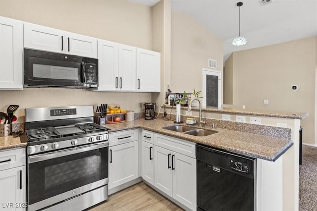 kitchen with visible vents, a peninsula, a sink, black appliances, and white cabinets