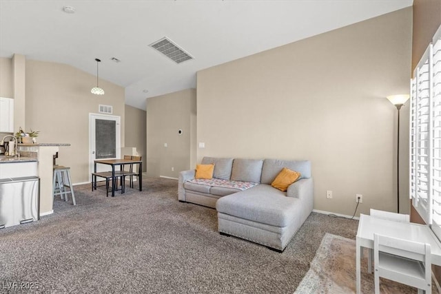 living room featuring visible vents, carpet flooring, baseboards, and vaulted ceiling