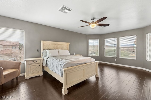 bedroom with ceiling fan, dark wood-style floors, visible vents, and baseboards