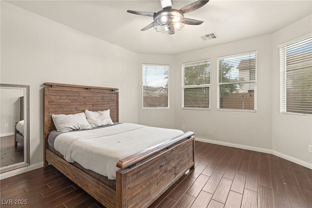 bedroom featuring wood finish floors, visible vents, baseboards, and a ceiling fan