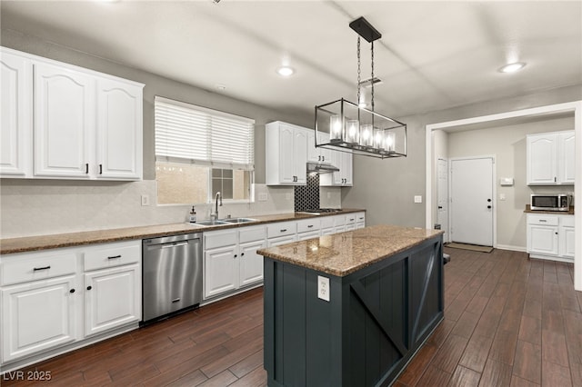 kitchen with a sink, appliances with stainless steel finishes, dark wood-style flooring, and white cabinetry